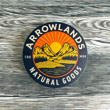 Arrowlands logo sticker placed on a wooden table